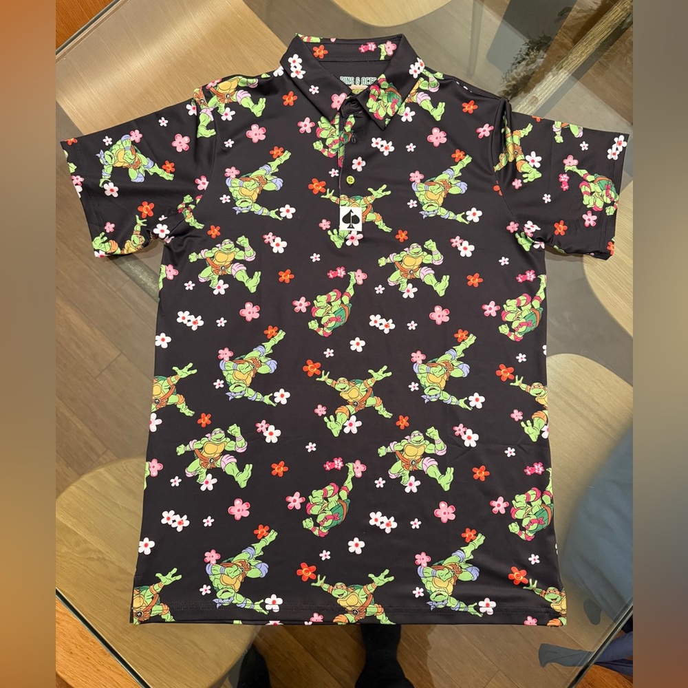 Men's Black Floral Pins & Aces Graphic Polo with Ninja Turtles Print